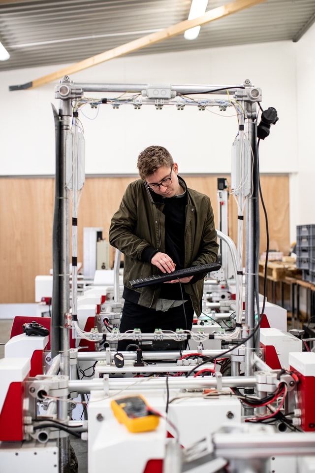 A person assembling parts in a construction line